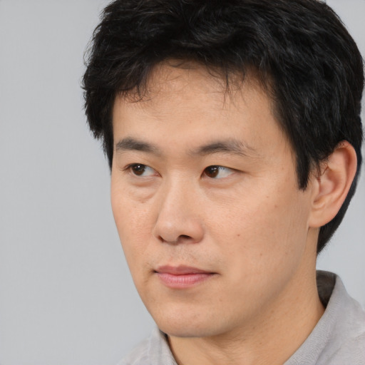 Neutral asian young-adult male with short  brown hair and brown eyes