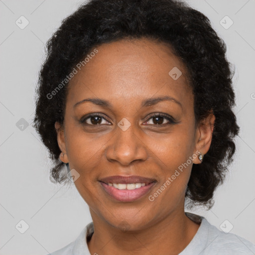 Joyful black adult female with short  brown hair and brown eyes