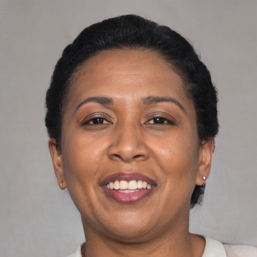 Joyful latino adult female with short  black hair and brown eyes