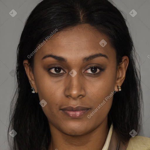 Joyful black young-adult female with long  brown hair and brown eyes