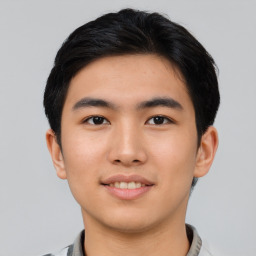 Joyful asian young-adult male with short  black hair and brown eyes