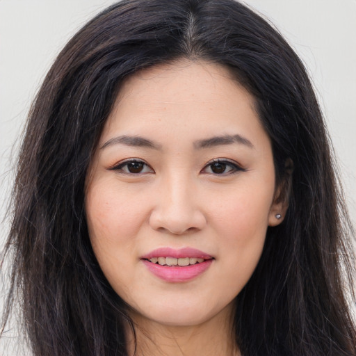 Joyful asian young-adult female with long  brown hair and brown eyes
