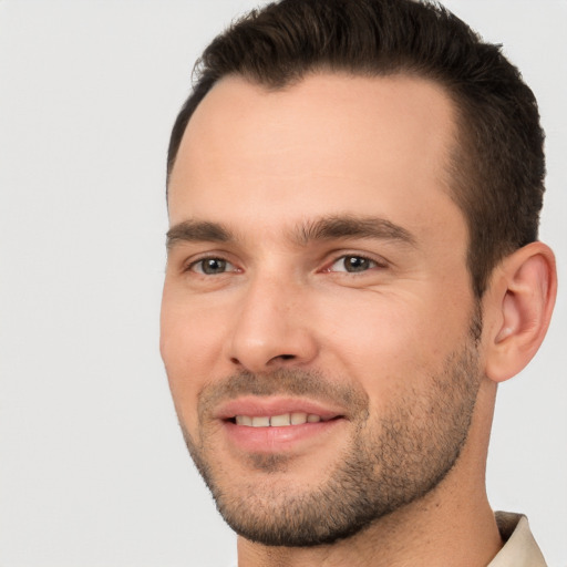 Joyful white young-adult male with short  brown hair and brown eyes