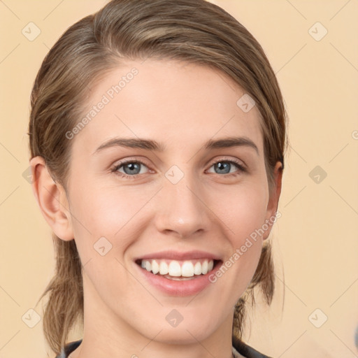 Joyful white young-adult female with medium  brown hair and green eyes