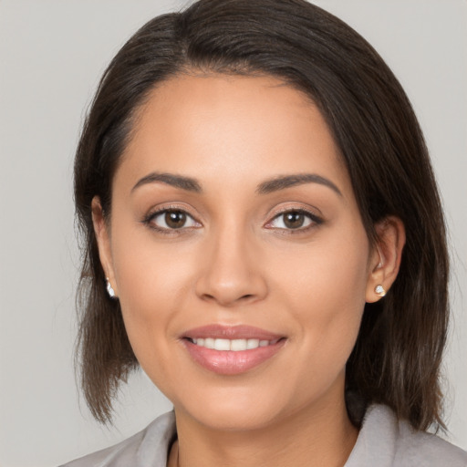 Joyful white young-adult female with medium  brown hair and brown eyes