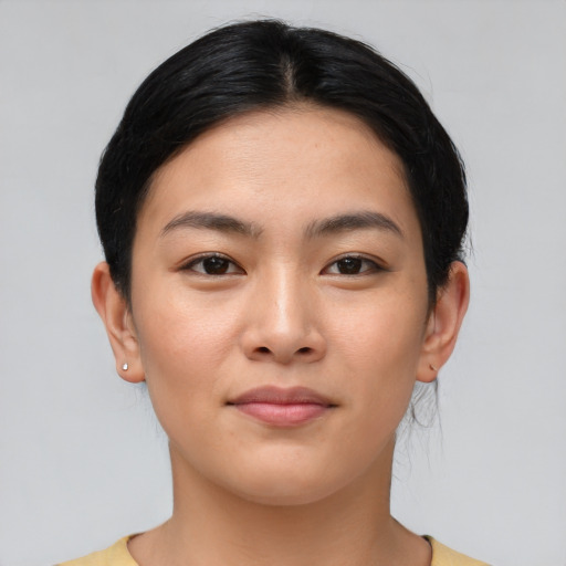 Joyful asian young-adult female with medium  brown hair and brown eyes