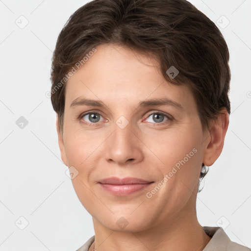 Joyful white young-adult female with short  brown hair and grey eyes