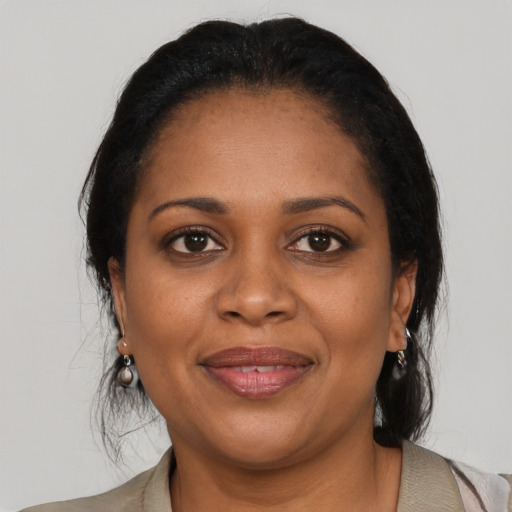 Joyful black adult female with medium  black hair and brown eyes