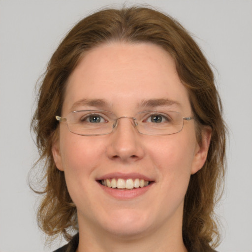 Joyful white adult female with medium  brown hair and green eyes