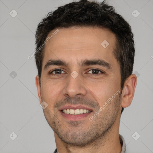 Joyful white young-adult male with short  black hair and brown eyes