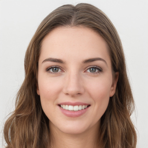 Joyful white young-adult female with long  brown hair and grey eyes