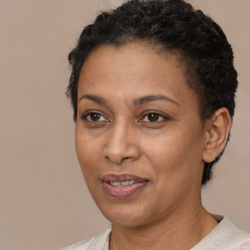 Joyful latino adult female with short  black hair and brown eyes
