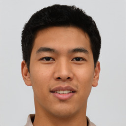 Joyful asian young-adult male with short  brown hair and brown eyes