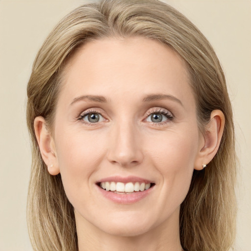 Joyful white young-adult female with long  brown hair and blue eyes