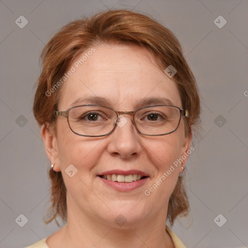 Joyful white adult female with medium  brown hair and blue eyes