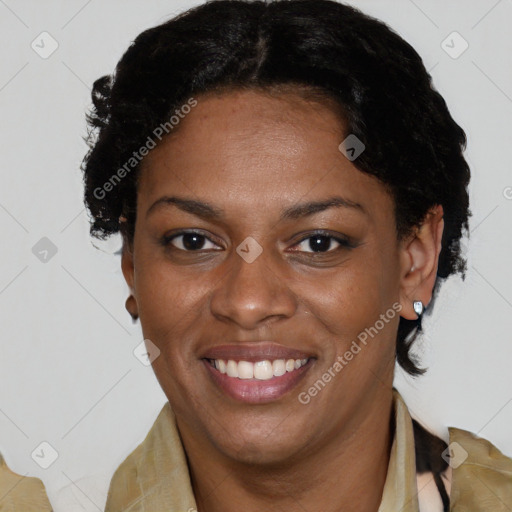 Joyful black adult female with short  brown hair and brown eyes