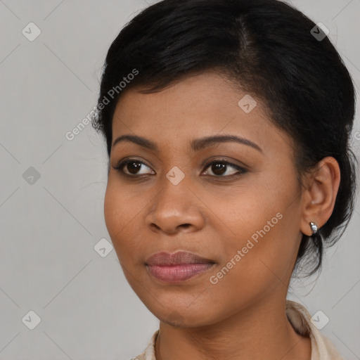 Joyful black young-adult female with long  brown hair and brown eyes