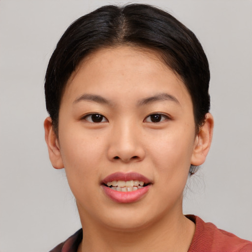 Joyful asian young-adult female with short  brown hair and brown eyes
