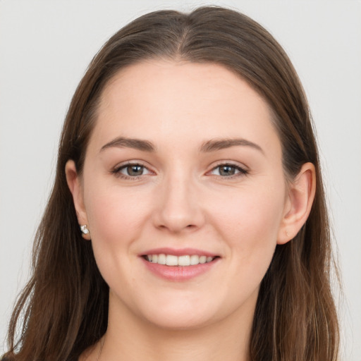 Joyful white young-adult female with long  brown hair and grey eyes