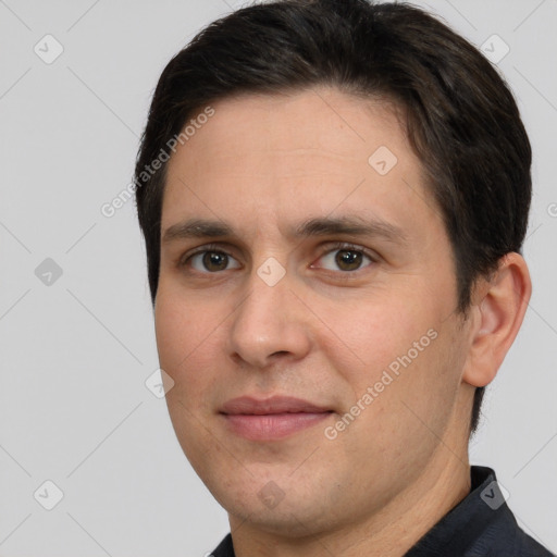 Joyful white adult male with short  brown hair and brown eyes