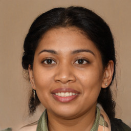 Joyful latino young-adult female with medium  brown hair and brown eyes