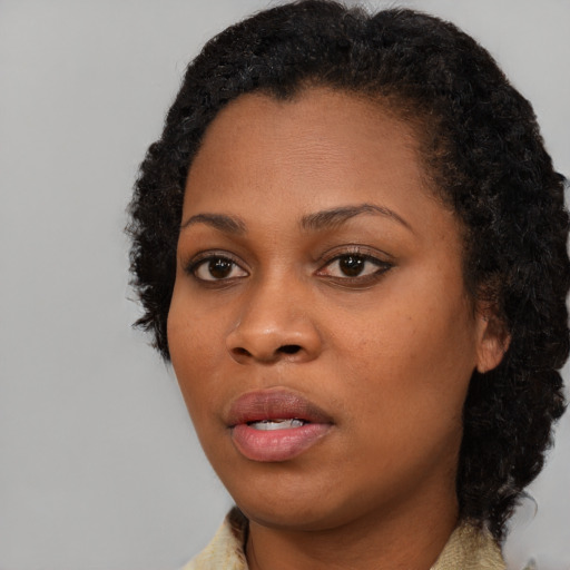 Neutral black young-adult female with short  black hair and brown eyes
