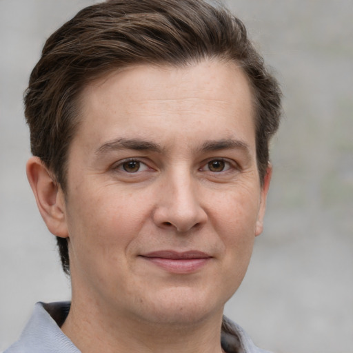 Joyful white adult male with short  brown hair and grey eyes