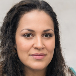 Joyful latino young-adult female with long  brown hair and brown eyes