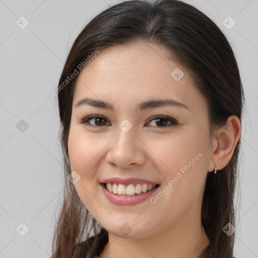 Joyful white young-adult female with long  brown hair and brown eyes