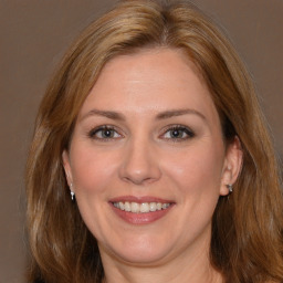 Joyful white adult female with medium  brown hair and brown eyes