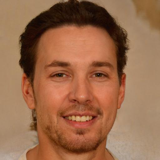 Joyful white adult male with short  brown hair and brown eyes