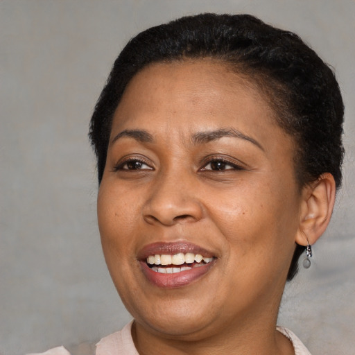 Joyful black adult female with short  brown hair and brown eyes