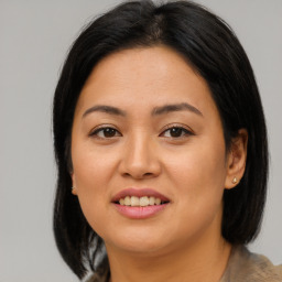 Joyful asian young-adult female with medium  brown hair and brown eyes