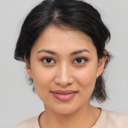 Joyful latino young-adult female with medium  brown hair and brown eyes