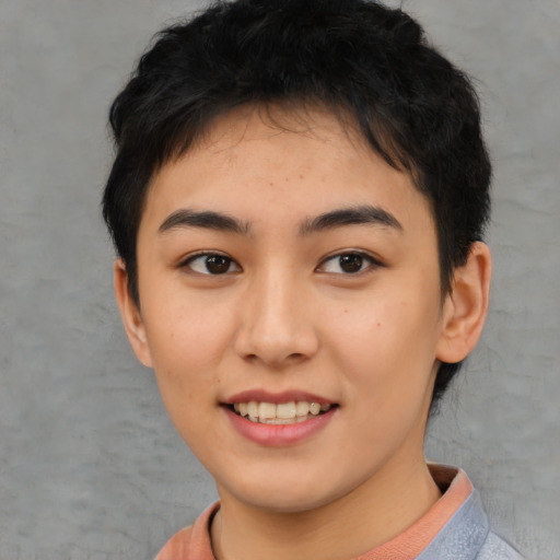 Joyful asian young-adult female with short  black hair and brown eyes