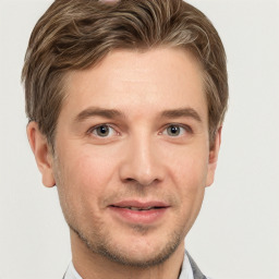 Joyful white young-adult male with short  brown hair and grey eyes