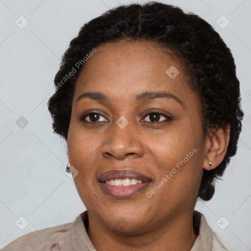 Joyful black adult female with short  brown hair and brown eyes