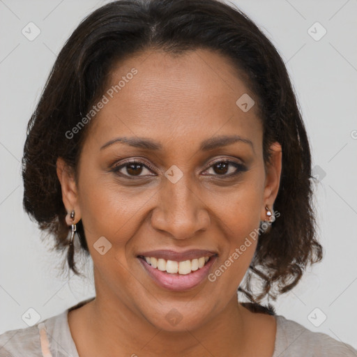 Joyful black adult female with medium  brown hair and brown eyes