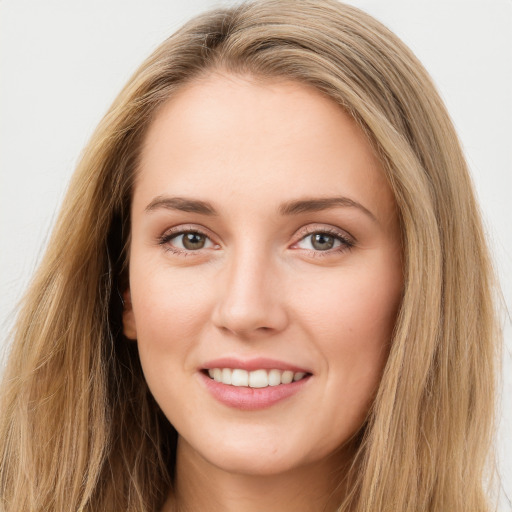 Joyful white young-adult female with long  brown hair and green eyes