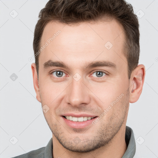 Joyful white young-adult male with short  brown hair and brown eyes