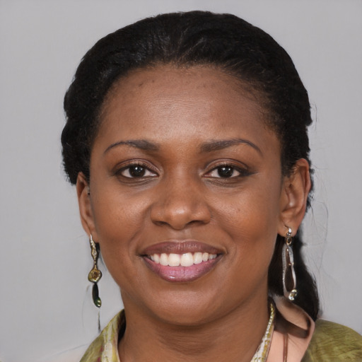 Joyful black young-adult female with medium  brown hair and brown eyes