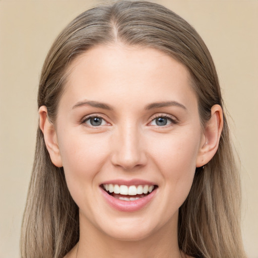 Joyful white young-adult female with long  brown hair and grey eyes