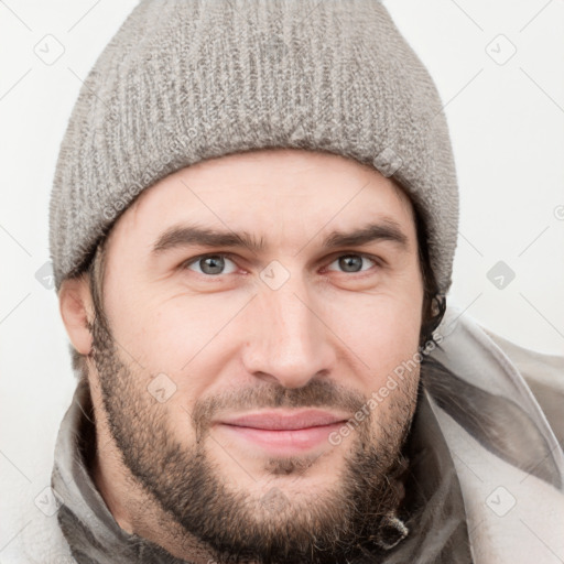 Joyful white young-adult male with short  brown hair and grey eyes