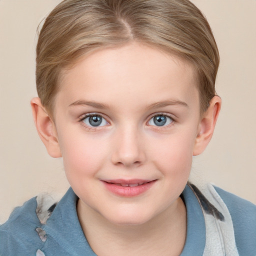 Joyful white child female with short  brown hair and blue eyes