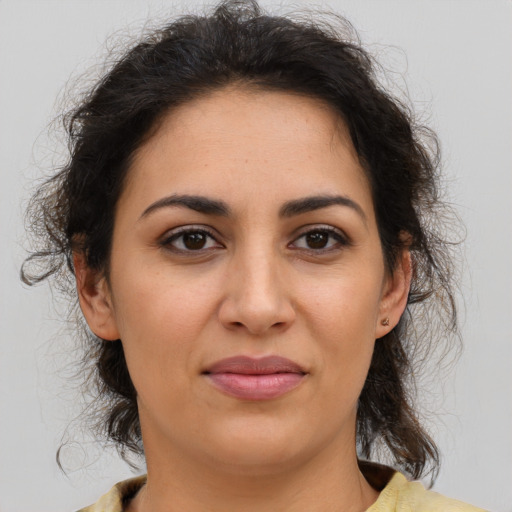 Joyful latino adult female with medium  brown hair and brown eyes