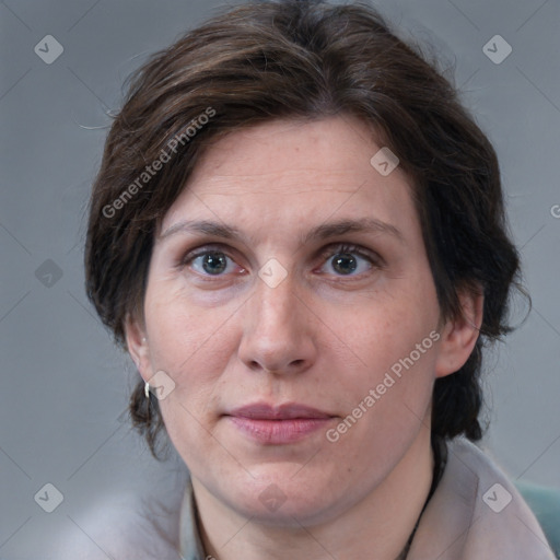 Joyful white adult female with medium  brown hair and grey eyes