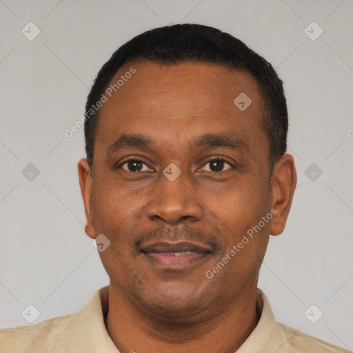 Joyful latino adult male with short  black hair and brown eyes