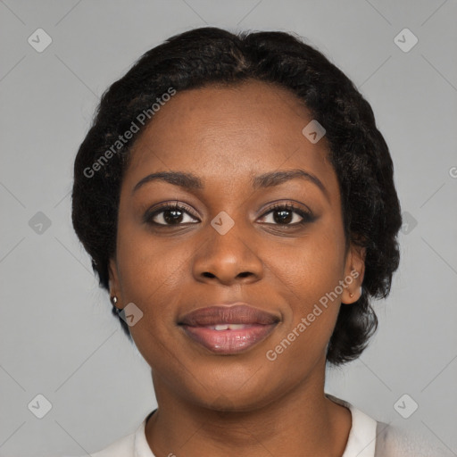 Joyful black young-adult female with short  black hair and brown eyes