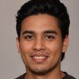 Joyful white young-adult male with short  black hair and brown eyes