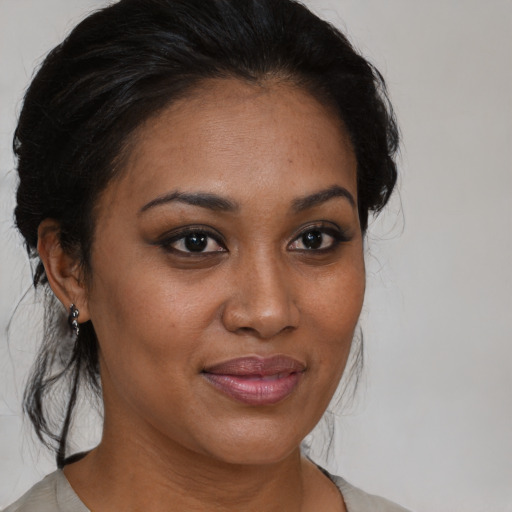 Joyful black young-adult female with medium  brown hair and brown eyes